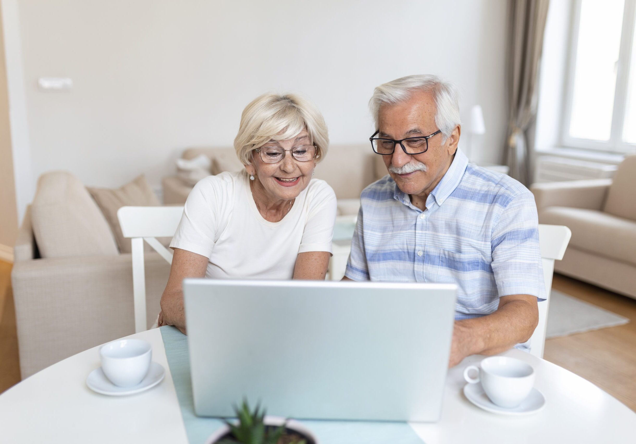 Senior couple is talking online via video connection on the laptop. Having nice time withfriends and family via video call. Senior couple is talking online via video connection on the laptop. Having nice time withfriends and family via video call.